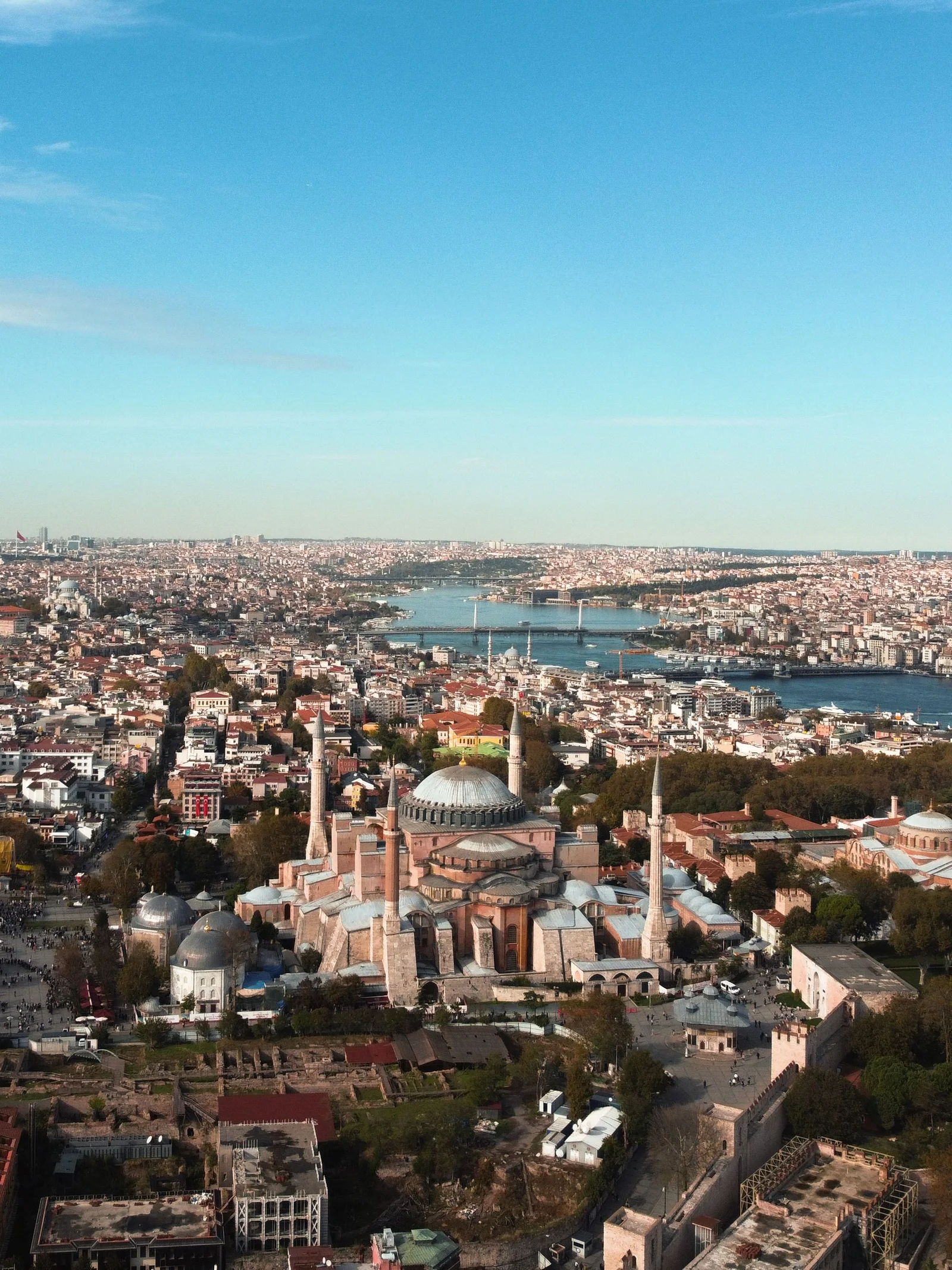 A breathtaking aerial shot of Hagia Sophia and Istanbul's sprawling cityscape under a clear blue sky.