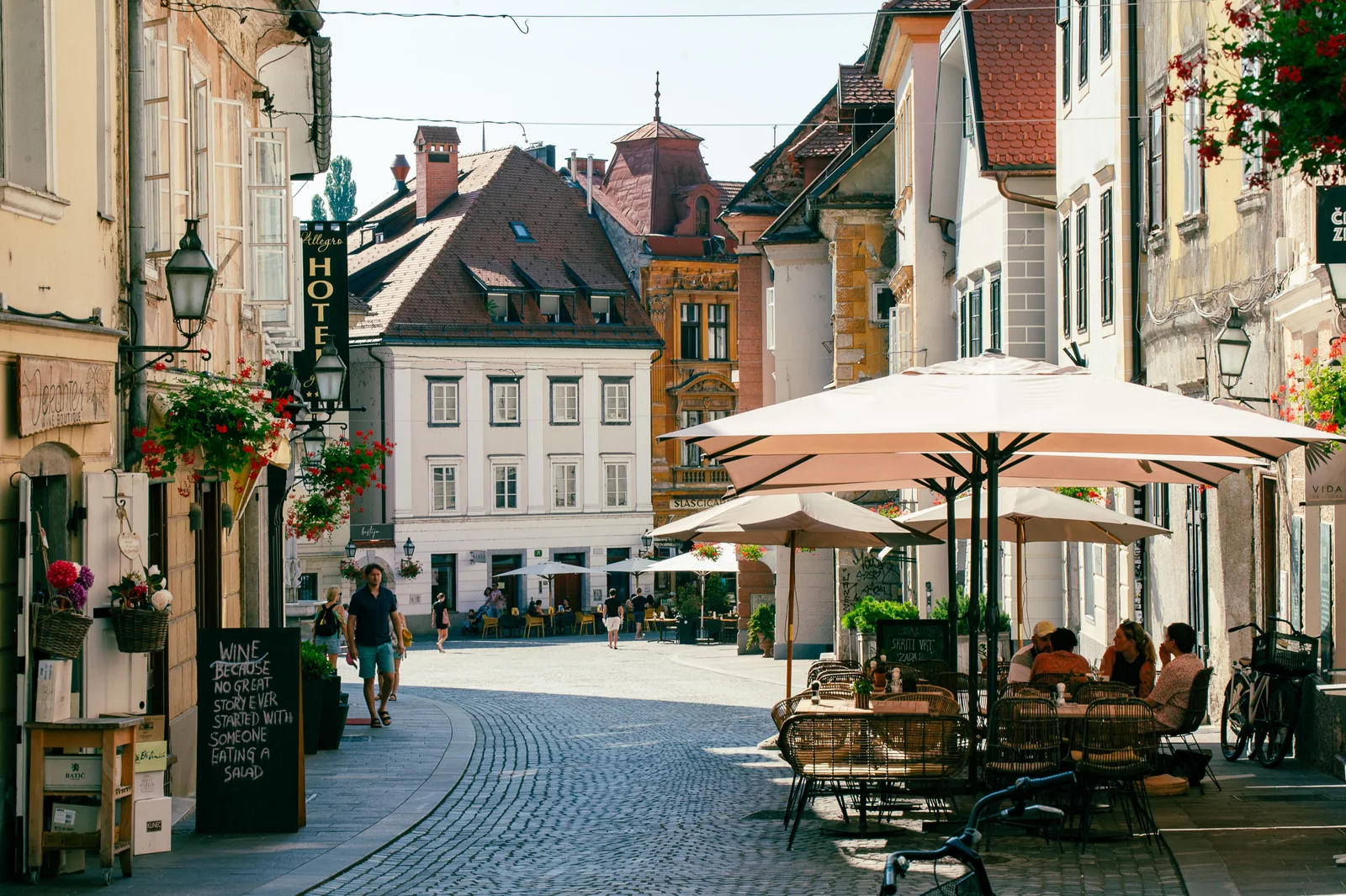 Discover the charm of Ljubljana's Old Town with this scenic street cafe view.