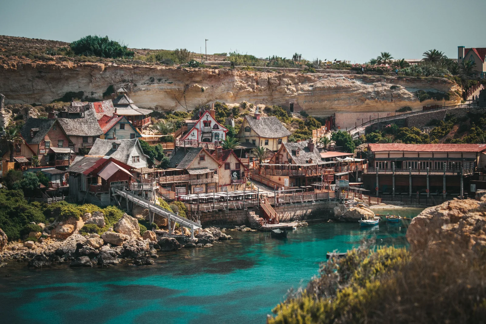 Charming coastal village with colorful houses by the blue sea under the clear sky.