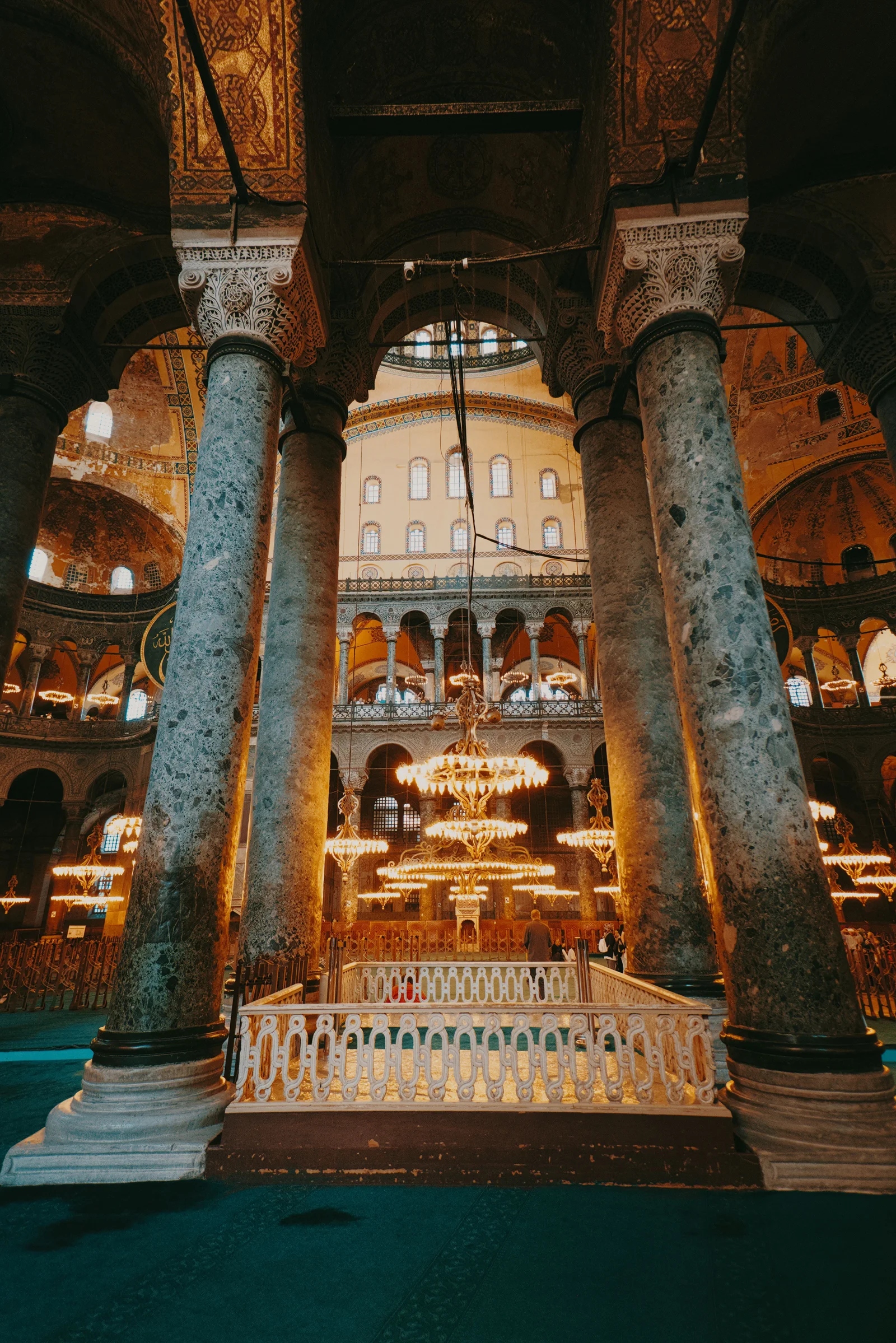 Majestic view of the mosque's ornate columns and chandeliers.