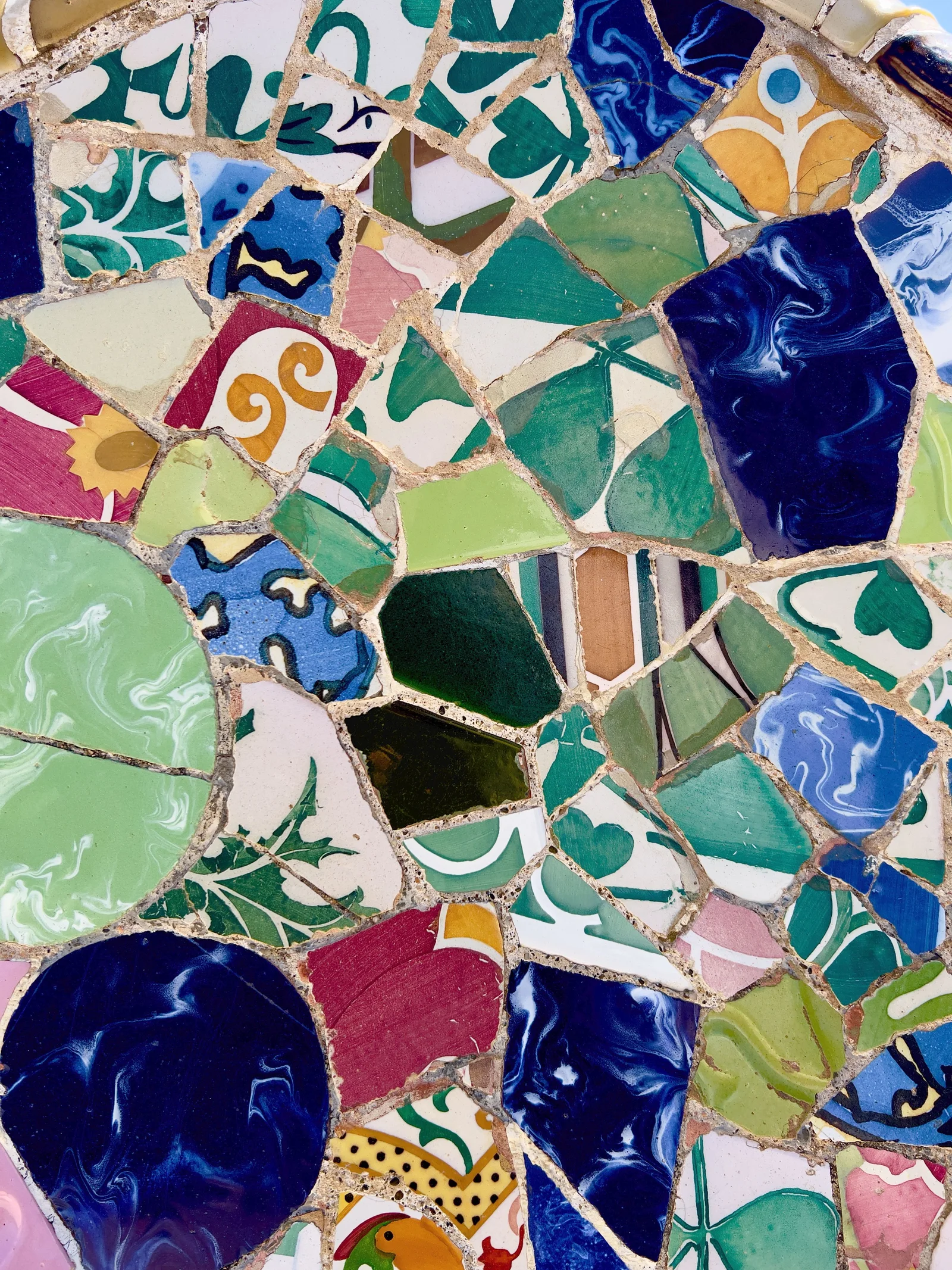 Vibrant Gaudi-style mosaic wall in Barcelona showcasing colorful ceramic patterns.