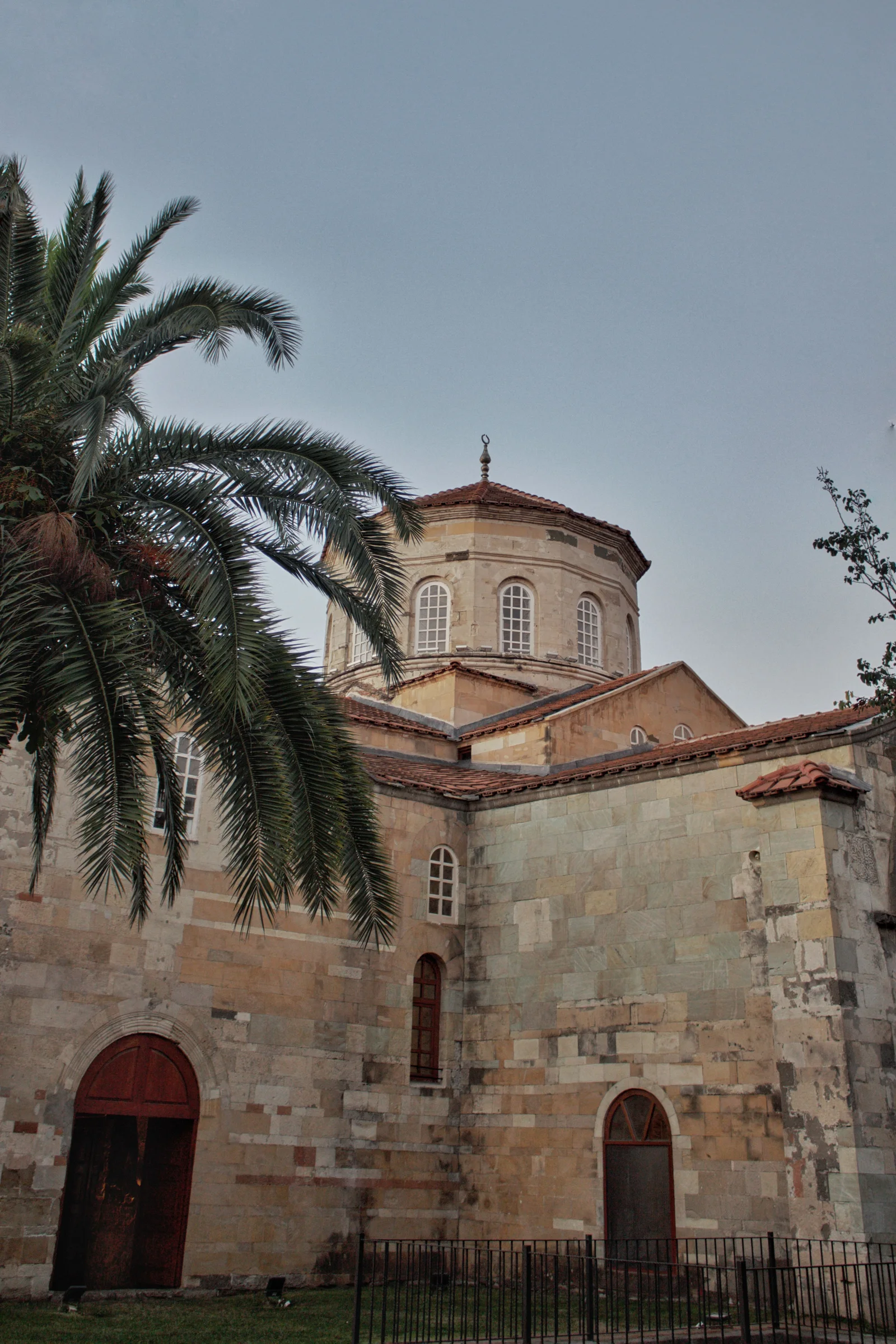 Historic view of Hagia Sophia Mosque with palm trees in Trabzon, Turkey.